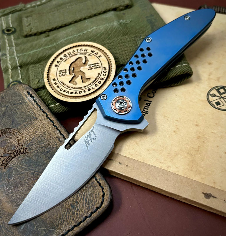 NK&T Custom Hydra Framelock with 5/32 Magnacut Blade, Two Tone Ti Speedhole Handles, Blue Ti Hardware and Copper Pivot Collar